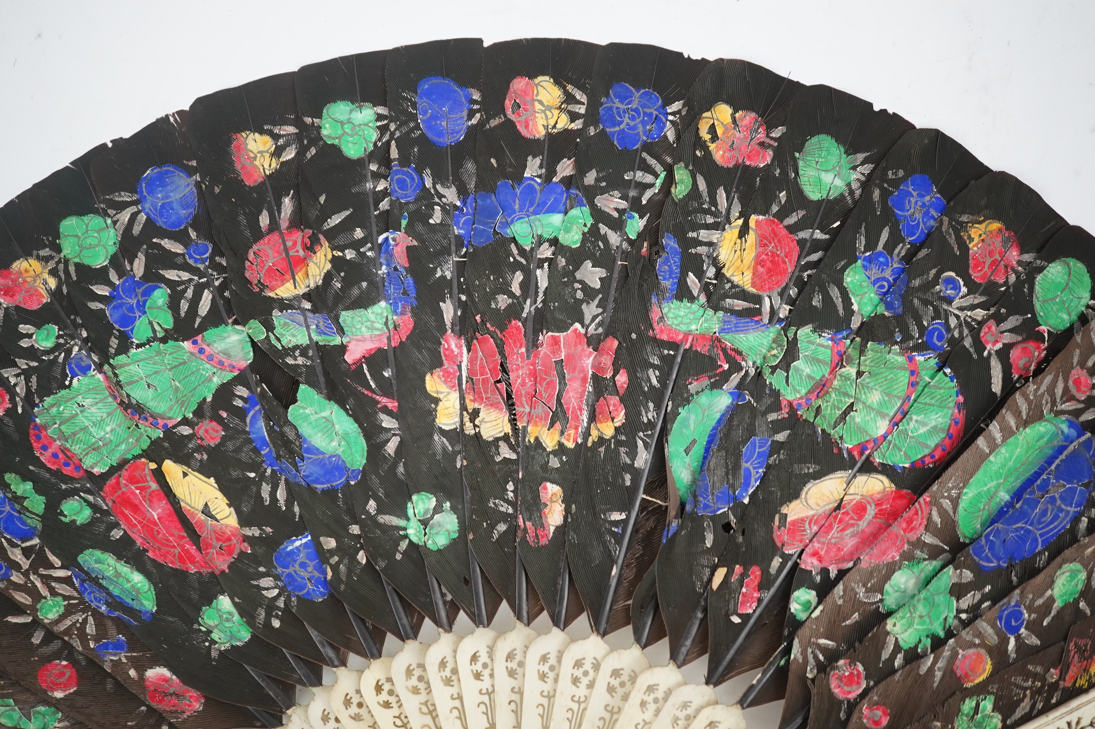 Three 19th century Chinese feather fans: One a carved bone brise black feather fan together with two similar carved sandalwood feather fans, two fans have hand painted decoration on the feathers both sides, the pink feat